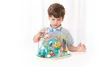 A young boy is playing with a wooden bead maze toy. Produktbild-Vorschau