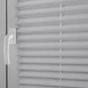 A close-up view of a white window handle and light gray blinds. Produktbild-Vorschau