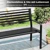 A black metal park bench is shown outdoors on a patio with grass and plants in the background. Produktbild-Vorschau