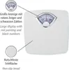 A white mechanical scale with a close-up of its analog display and a close-up of its non-slip tread. Text labels describe the features in German and English. Produktbild-Vorschau