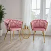 Two pink velvet chairs with gold legs are placed in a room with a window and a plant. Produktbild-Vorschau