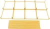 A gold metal frame structure and a stack of gold metal rods against a white background. Podgląd zdjęcia produktu