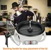 A man in a hat is pouring liquid from a kettle into a coffee brewing apparatus, with a coffee roaster in the foreground. Produktbild-Vorschau