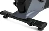A close-up view of the base of an exercise bike, showing the stabilizing bar and part of the main body. Produktbild-Vorschau