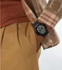 Close-up of a person wearing a digital watch on their wrist, with parts of their clothing visible. Náhled obrázku produktu
