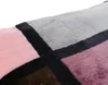 A close-up view of a soft blanket with a geometric pattern. Produktbild-Vorschau