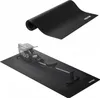 A black exercise mat is shown, both rolled up and unrolled with a rowing machine on top. Podgląd zdjęcia produktu