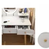 A close-up view of a white vanity table with drawers and a mirror. Produktbild-Vorschau