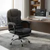A black office chair is placed on a rug in front of a desk with a computer and a bookshelf in the background. A large window with a city view is to the left. Podgląd zdjęcia produktu
