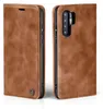 A brown leather flip case for a smartphone is shown from two angles. Produktbild-Vorschau