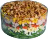 A layered salad in a glass bowl, topped with nuts. Podgląd zdjęcia produktu