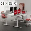 Two white height-adjustable desks with monitors and chairs in a modern office setting. Podgląd zdjęcia produktu
