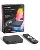 A product shot of a STRONG SRT420 Android TV box and its remote, with the product packaging in the background. Voir les images du produit