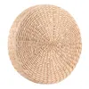 A round, thick seat cushion or pouf made of woven natural material, presented on a white background. Voir les images du produit