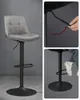 A bar stool with a detail view of its height adjustment mechanism and a person demonstrating its use. Náhled obrázku produktu