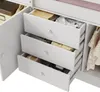 Close-up view of drawers and hanging clothes in a white wardrobe or dresser. Náhled obrázku produktu