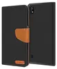 A black flip case for a Samsung Galaxy A10 phone, with a brown leather strap and a small brown logo on the front. Náhľad obrázku produktu