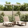 Two lounge chairs and a patio umbrella are set up on a wooden deck in a backyard setting, surrounded by lush green bushes and a wooden fence. Podgląd zdjęcia produktu