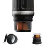 Close-up view of a portable coffee machine's lower section, showing internal components and separate accessories. Produktbild-Vorschau