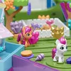 A toy playset with small pony figures and accessories, set in a colorful, miniature outdoor environment. Produktbild-Vorschau