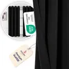 A close-up of a black curtain with a tag showing a certification and another tag with product information. Produktbild-Vorschau