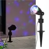 Two LED party lights projecting colorful dots onto a wall and patio. Produktbild-Vorschau