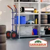 A hand truck is shown in a storage area next to shelves filled with various items. Anteprima dell’immagine prodotto