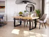 A dining room scene with a wooden table and chairs, set in a modern apartment. Produktbild-Vorschau