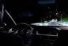 View from inside a car at night, looking out at a street with streetlights and other cars. Podgląd zdjęcia produktu