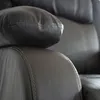 A close-up view of the stitching and texture of a brown leather recliner chair. Produktbild-Vorschau