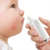 A close-up shot of a baby's cheek with a white electric nasal aspirator being held near the nose by a hand. Anteprima dell’immagine prodotto