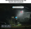 A person is standing in front of a house at night, illuminated by a security light. The image highlights the camera's features like motion detection and alarm. Náhled obrázku produktu