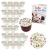 A collection of small glass jars with strawberry-themed lids, a single jar filled with jam, a recipe book, and a decorative plate, all arranged on a white background. Voir les images du produit