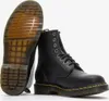 A pair of black Dr. Martens boots are shown against a white background. One boot is upright, showing the side and laces, while the other is lying on its side, displaying the sole. Voir les images du produit