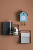 A cuckoo clock and two wall shelves are mounted on a brown wall. Produktbild-Vorschau