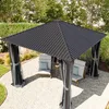 A garden gazebo with chairs and side tables set up in a backyard. Anteprima dell’immagine prodotto