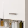 A close-up view of a white bathroom cabinet with a silver handle, showing several bottles and reed diffusers on the shelf below. Náhled obrázku produktu