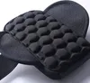 A close-up view of a black padded armband case, showing its textured surface and strap. Produktbild-Vorschau