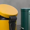 Close-up of a yellow pedal bin with other bins in the background. Voir les images du produit