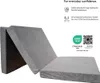 A folded gray mattress is shown against a white background. Voir les images du produit