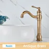 A close-up shot of an antique brass faucet over a white sink, with a marble-patterned wall in the background. Náhľad obrázku produktu
