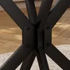 Close-up of the black metal legs of a table, showing the joinery and fasteners. Produktbild-Vorschau