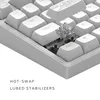 A close-up view of a white mechanical keyboard with a keycap removed to show the switch and stabilizer. Náhľad obrázku produktu