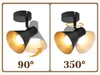 Two panels showing a black and gold spotlight with adjustable angles, illustrating its 90° and 350° movement capabilities. Náhľad obrázku produktu