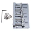 A chrome-plated 5-string bass guitar bridge with included screws and an Allen wrench, laid out on a white background. Podgląd zdjęcia produktu