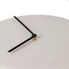 A close-up view of a clock face with black hands. Voir les images du produit