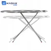 A KADAX folding ironing board is shown against a white background. The ironing board has a checkered pattern and is shown in a slightly transparent, ghosted state to indicate adjustability. Produktbild-Vorschau