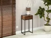 A narrow console table with a drawer, a lamp, and a potted plant in a room with blinds. Náhled obrázku produktu