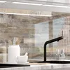 A kitchen backsplash with a wood plank design, featuring kitchen utensils and a faucet. Produktbild-Vorschau