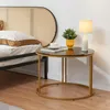 A bedside table with a lamp and a plant next to a bed with a rattan headboard. Produktbild-Vorschau